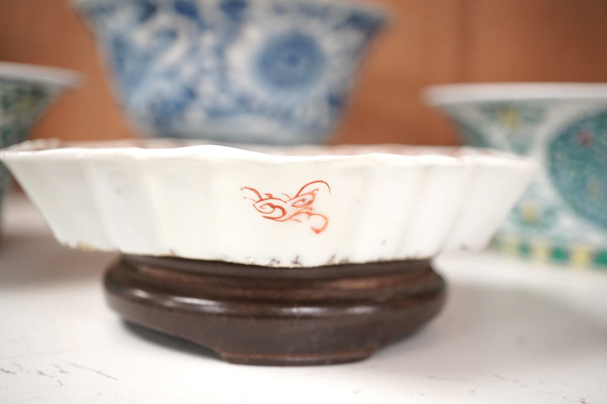 A Chinese blue and white bowl, Kangxi, 15cm. diam., a famille rose teapot stand, Yongzheng, and two doucai bowls. Condition - varies